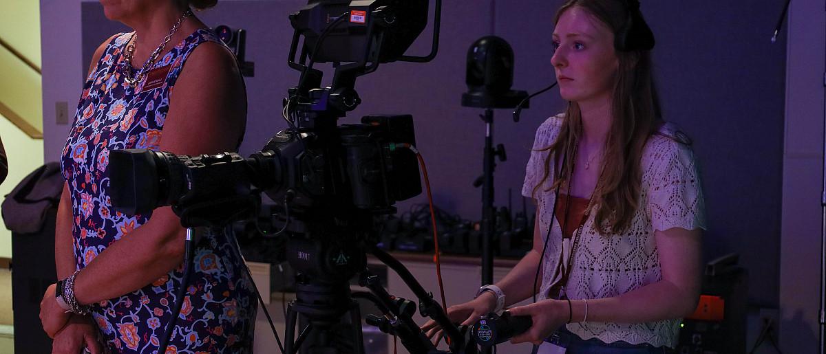 Image of GO Media students working cameras in video studio.